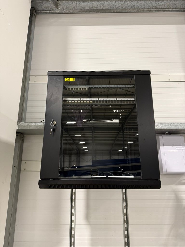 Finished wall cabinet labelled CAB 3 mounted on a warehouse wall