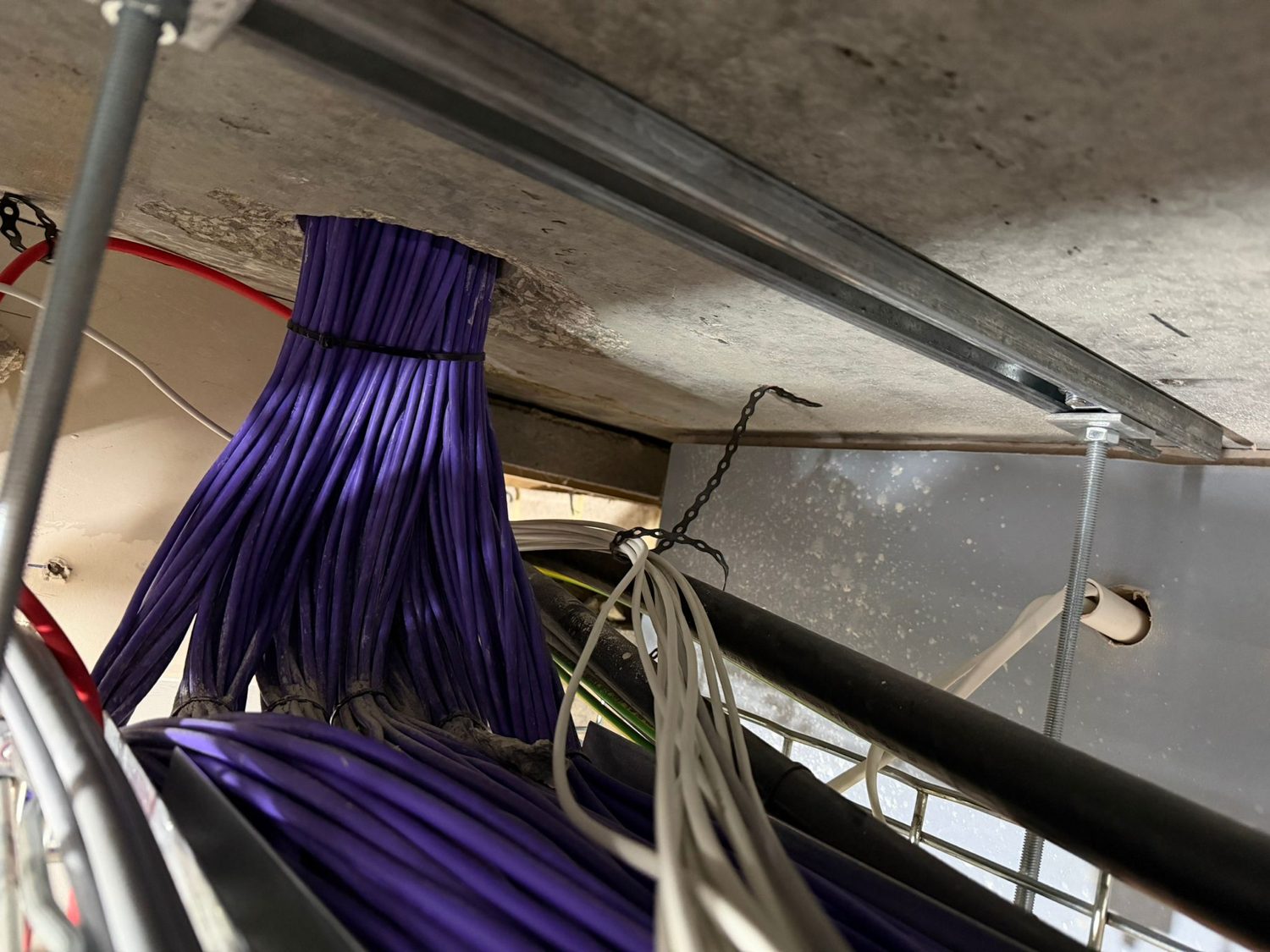 Bundle of network cables dressed onto overhead containment
