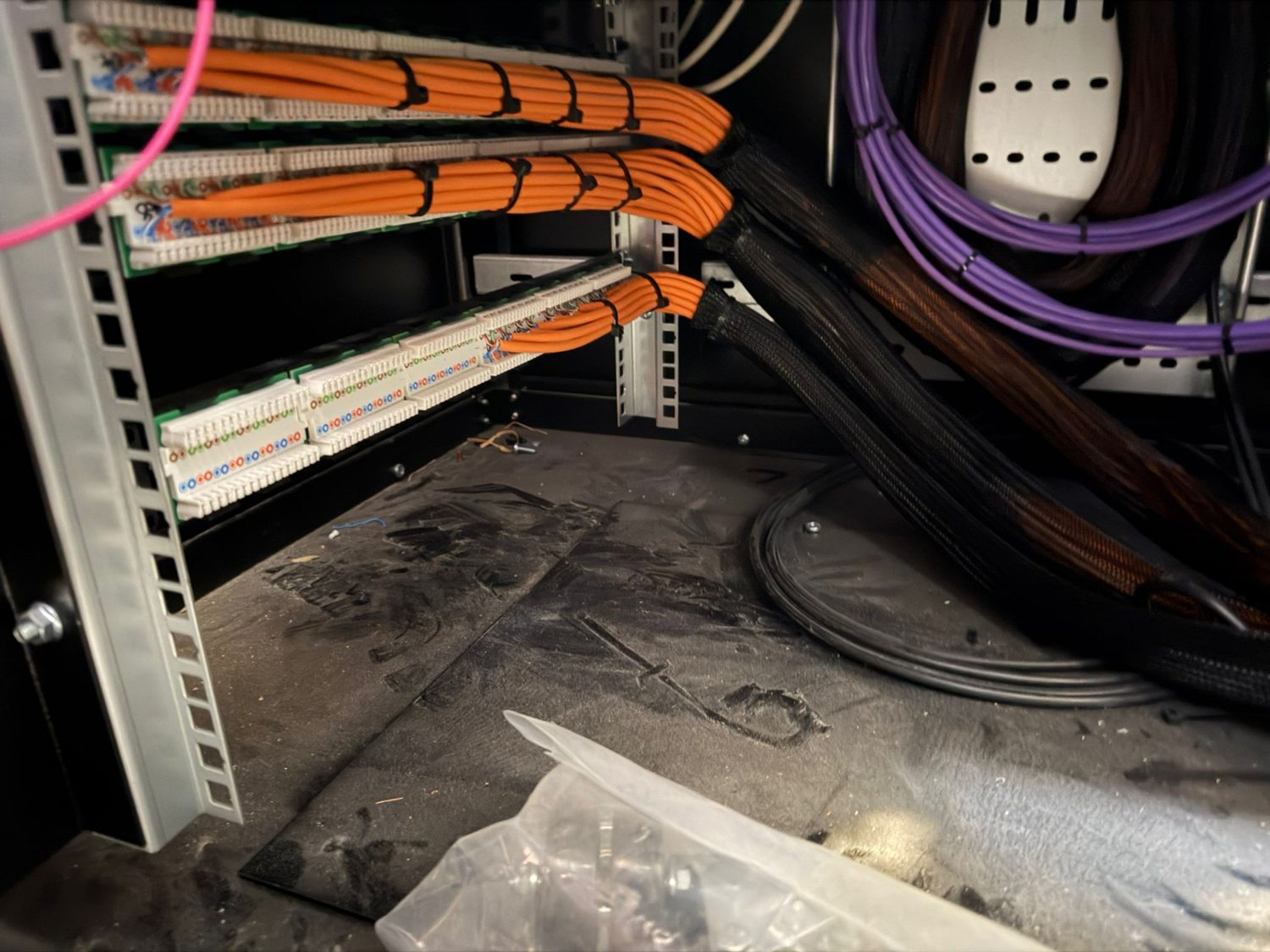 Orange and purple containment carrying data cabling overhead