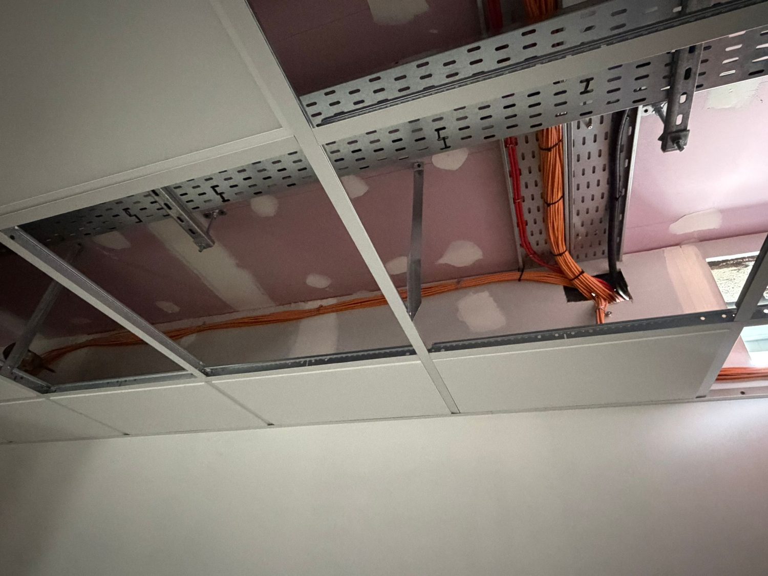 Cable tray installed across a ceiling void